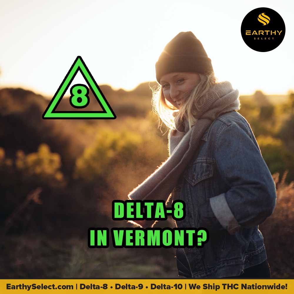 In the Vermont outdoors, stoned woman in fall clothes looks at camera. Earthy Select logo, Delta-8 logo