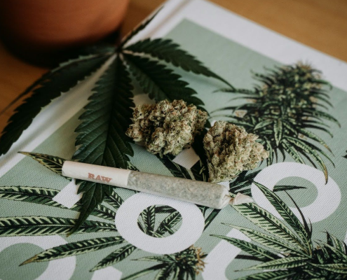 Cannabis Flower, Hemp, And A Pre-Roll On A Table