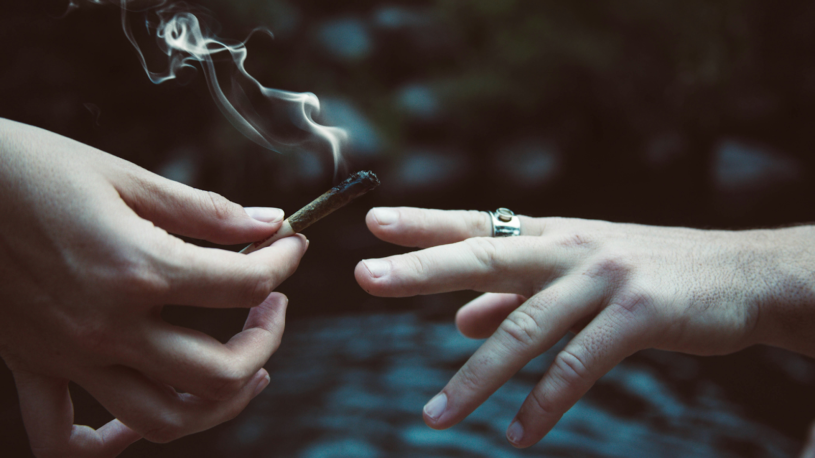 Friends passing a joint to one another