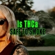 Woman wearing sunglasses smoking a THCa joint.