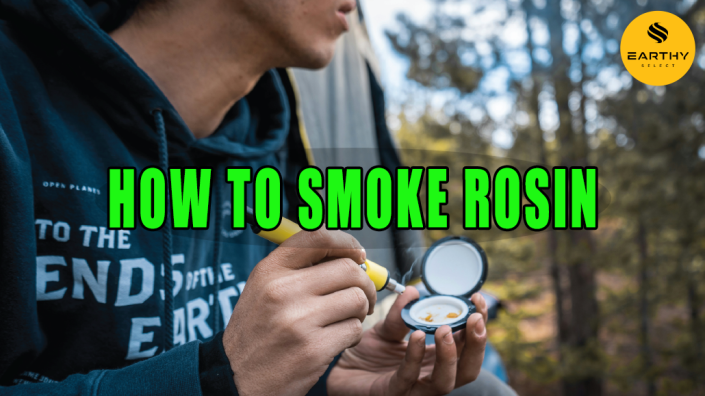 Man using dipping device to smoke rosin